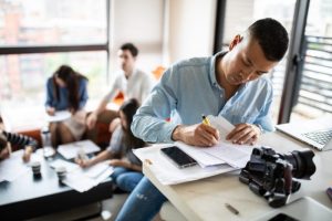Young Asian man writes down a plan
