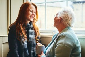 Young woman happily talking with an older lady