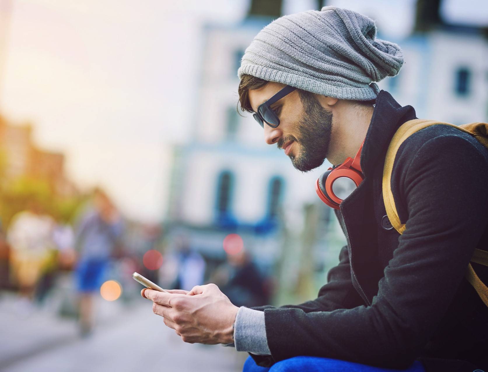 Shot of a young man using his mobile phone while out in the city