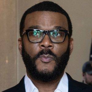 A person in a dark suit jacket and white shirt