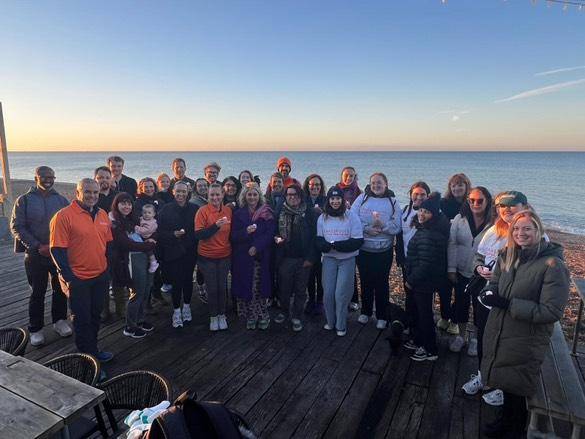 Group of people next to Brighton beach after a sponsored walk.