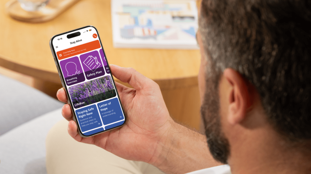Man on phone with stay alive app open.
