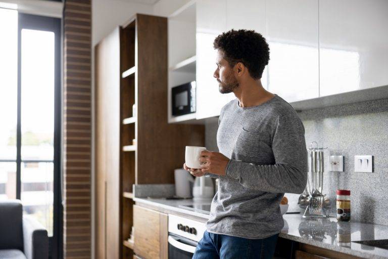 Man at home taking a break and drinking a cup of coffee stock photo