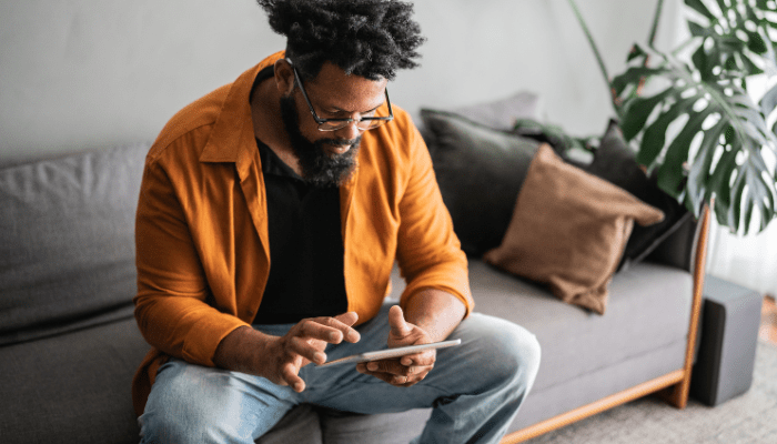 Mature man using digital tablet at home stock photo