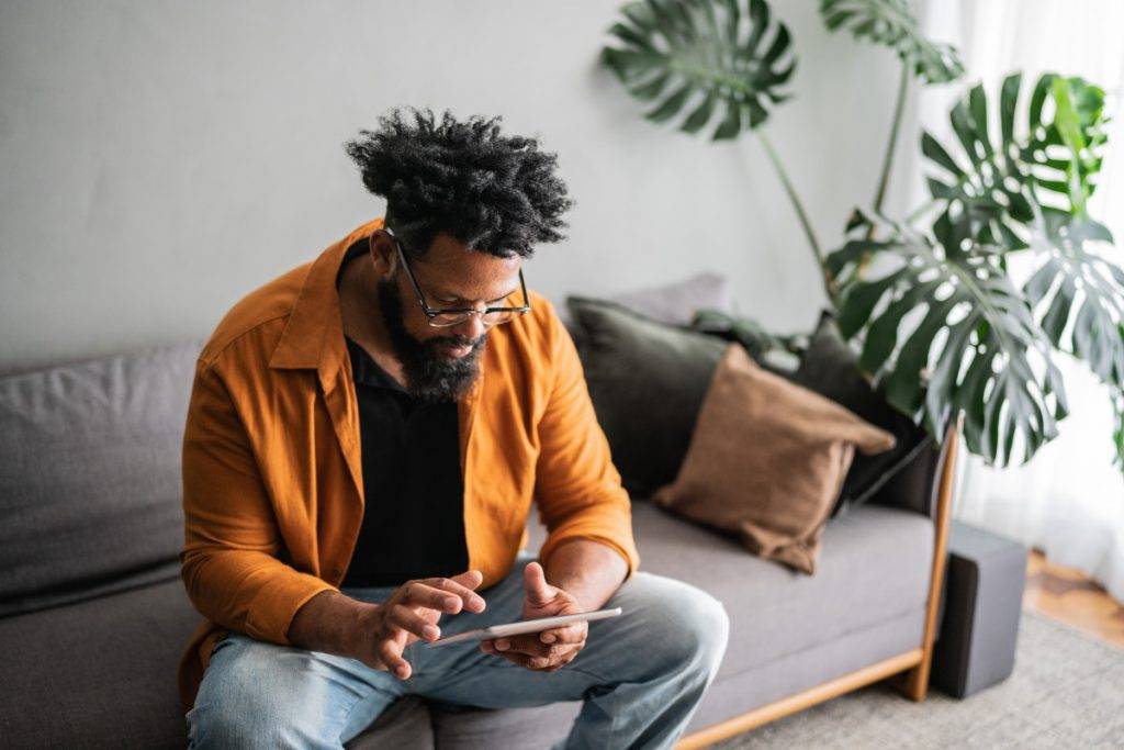 Mature man using digital tablet at home stock photo