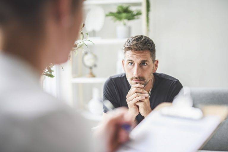 Man with psychologist theraphy social problems concept drug addiction talk to a psychological woman stock photo
