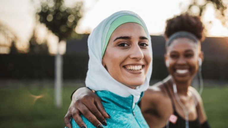Two women in sports gear smiling